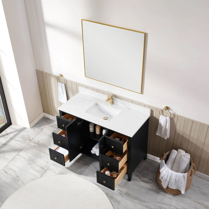 Bathroom vanity with double sink, mirrors, and towels in a well-lit room.