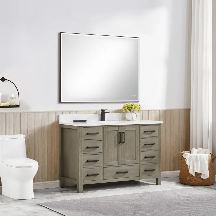 Bathroom vanity with wooden cabinets and white countertop, featuring a toilet and towel on the side.