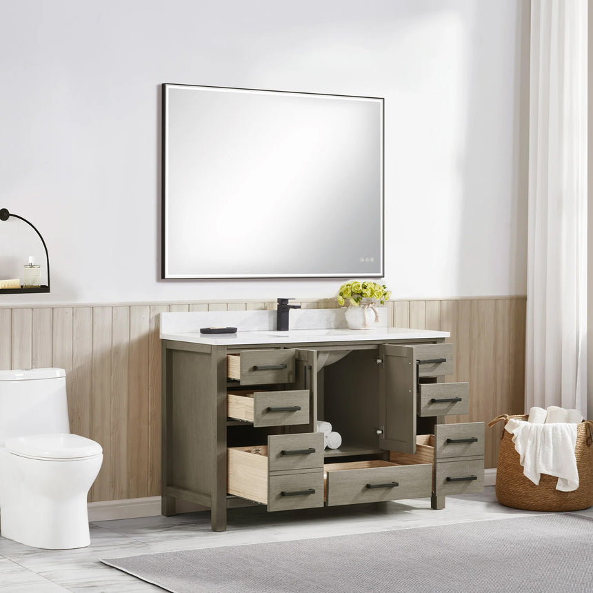 Bathroom vanity with wooden cabinets and white countertop, featuring a toilet and towel on the side.