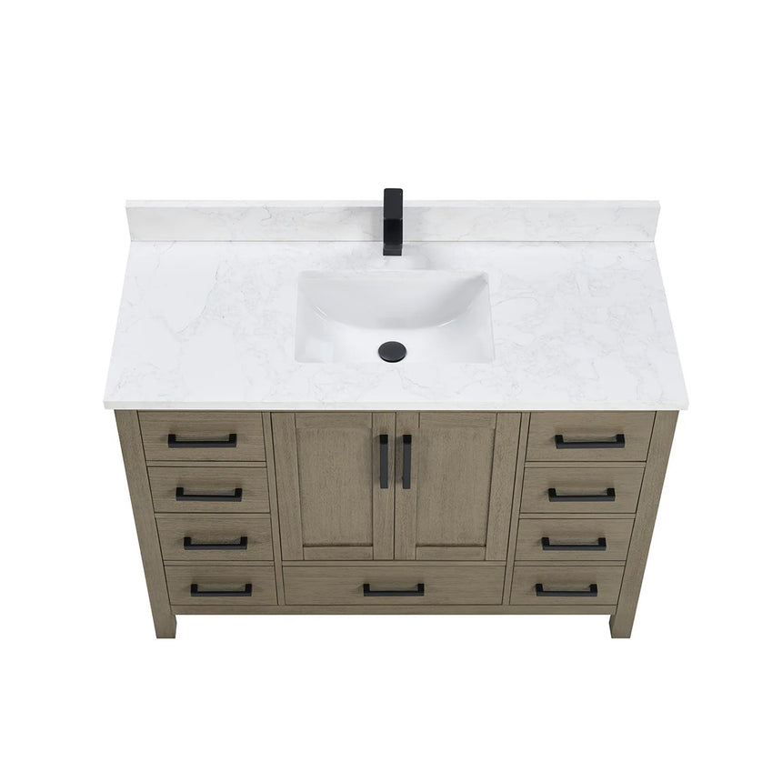 Bathroom vanity with wooden cabinets and white countertop, featuring a toilet and towel on the side.