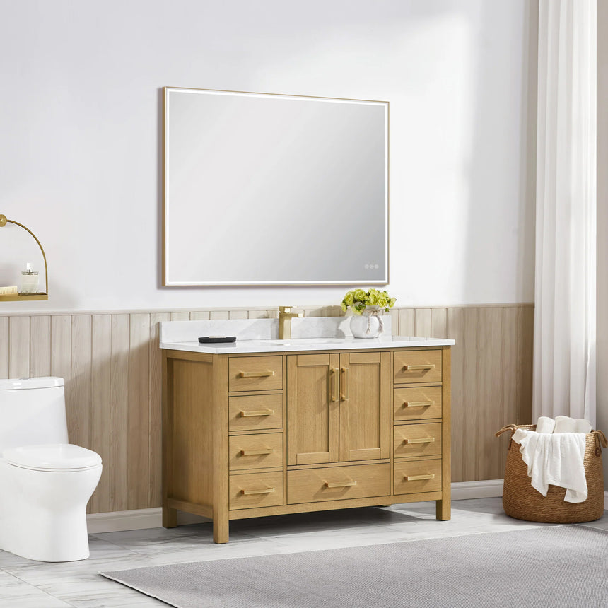 Bathroom vanity with wooden cabinets and white countertop, featuring a toilet and towel on the side.