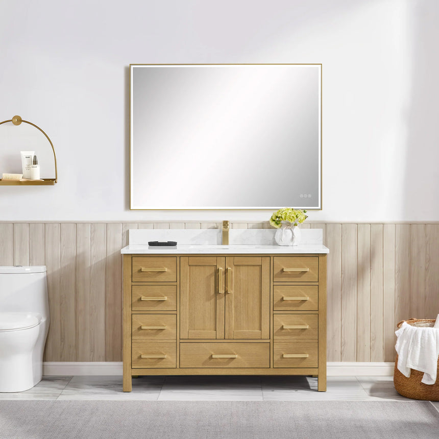 Bathroom vanity with wooden cabinets and white countertop, featuring a toilet and towel on the side.