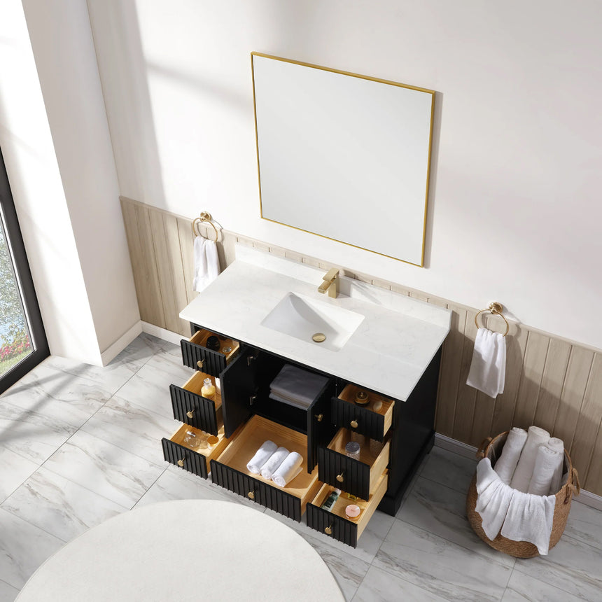 Bathroom vanity with wooden cabinet and white countertop in a bathroom setting.