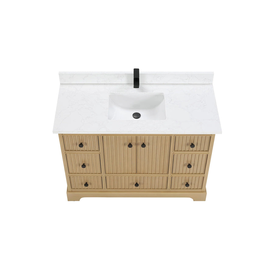 Bathroom vanity with wooden cabinet and white countertop in a bathroom setting.