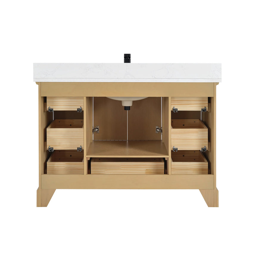 Bathroom vanity with wooden cabinet and white countertop in a bathroom setting.