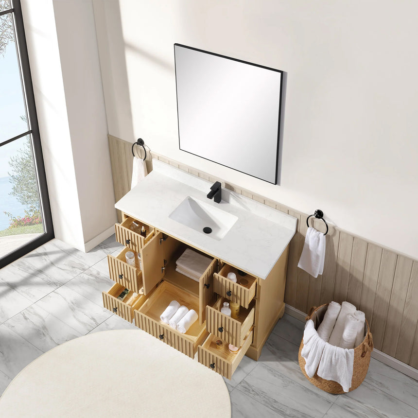 Bathroom vanity with wooden cabinet and white countertop in a bathroom setting.