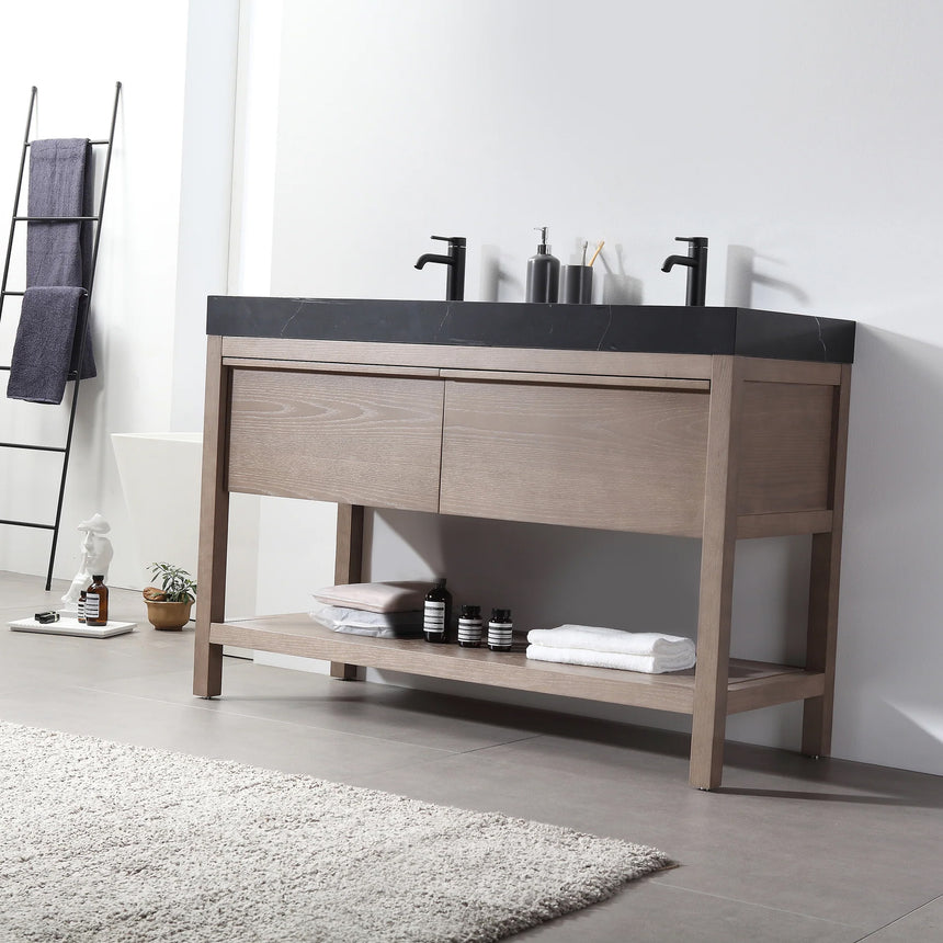 Bathroom vanity with black countertop and wooden cabinet in a bright room.