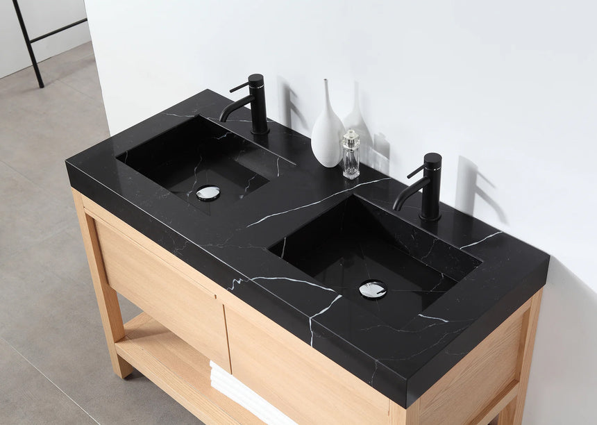 Bathroom vanity with black countertop and wooden cabinet in a bright room.