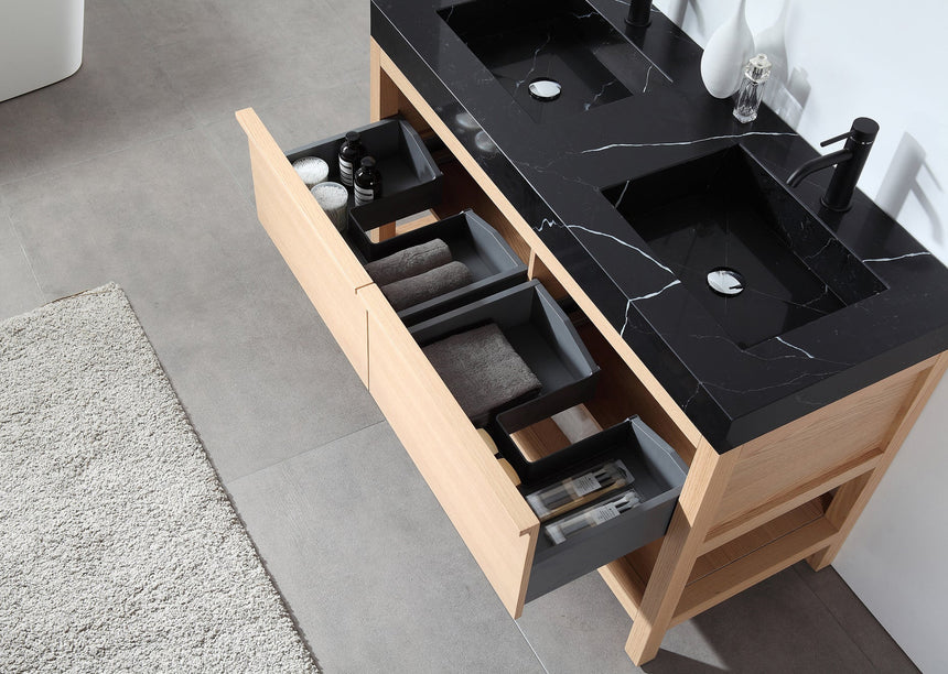 Bathroom vanity with black countertop and wooden cabinet in a bright room.