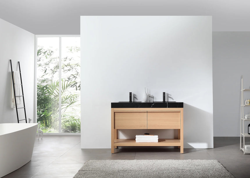 Bathroom vanity with black countertop and wooden cabinet in a bright room.