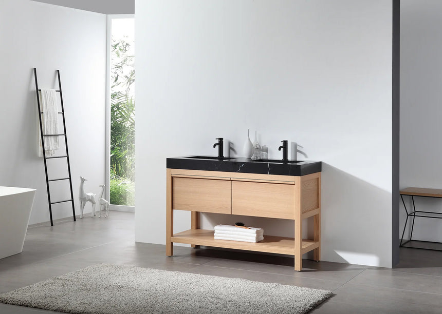 Bathroom vanity with black countertop and wooden cabinet in a bright room.