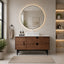 Bathroom with wooden vanity, round mirror, and decorative elements.