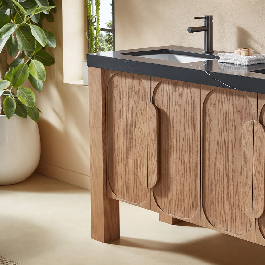 Bathroom with wooden vanity, white countertop, and decorative elements.