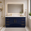 Bathroom with navy blue vanity, gold fixtures, and a large mirror.