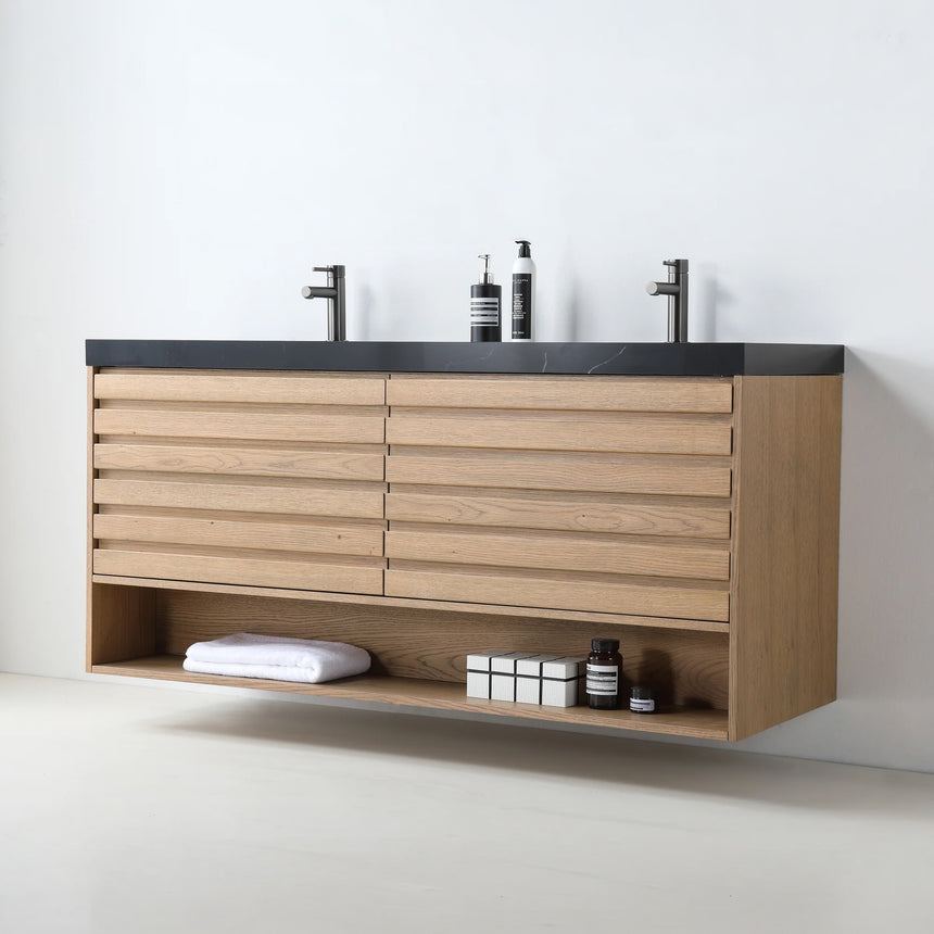 A modern floating bathroom vanity with a light oak wood finish, a white countertop, and an integrated sink, shown in a styled bathroom setting with a bathtub, shower glass, and decorative plants.