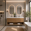 Modern bathroom vanity with two oval backlit mirrors, a light wood double-sink console, white countertops, wall-mounted sconces, and a large window with a free-form bathtub nearby.