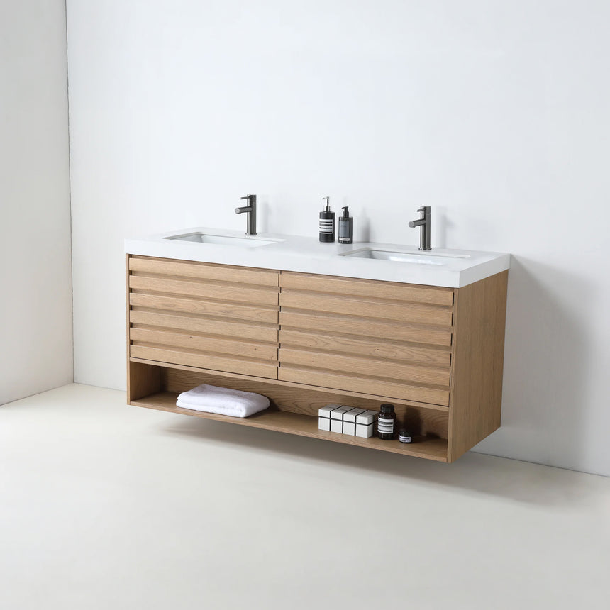 A modern floating bathroom vanity with a light oak wood finish, a white countertop, and an integrated sink, shown in a styled bathroom setting with a bathtub, shower glass, and decorative plants.