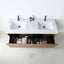 A modern double-sink bathroom vanity with a white rectangular countertop, two matte black faucets, open lower drawers, and toiletries visible inside, photographed against a clean white wall and floor.