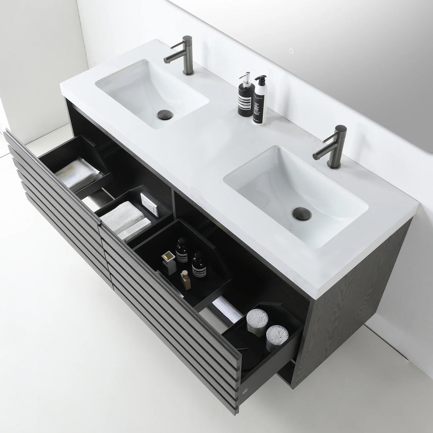 A modern floating bathroom vanity with a light oak wood finish, a white countertop, and an integrated sink, shown in a styled bathroom setting with a bathtub, shower glass, and decorative plants.