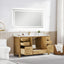 Bathroom with wooden vanity, sink, and mirror in a modern setting.