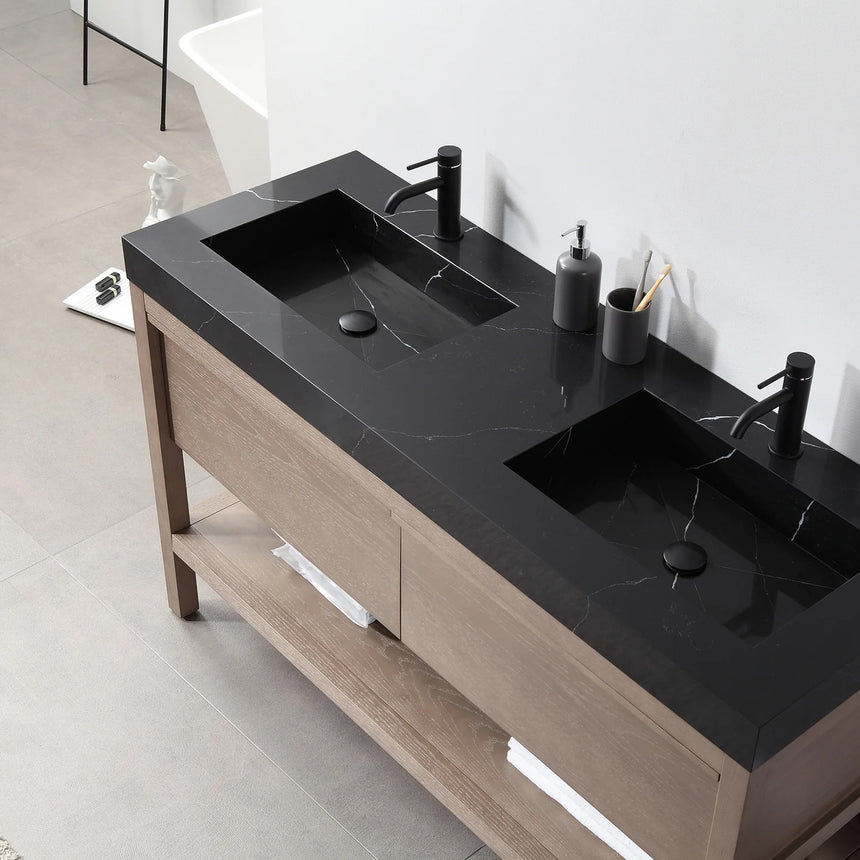 Bathroom vanity with black countertop and wooden cabinet in a bright room.