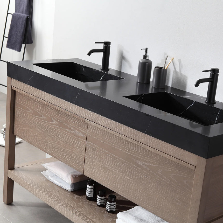 Bathroom vanity with black countertop and wooden cabinet in a bright room.