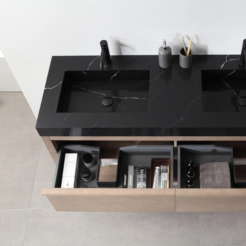 Bathroom vanity with black countertop and wooden cabinet in a bright room.