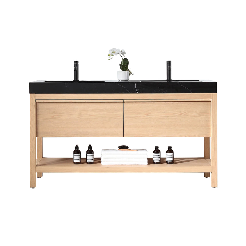 Bathroom vanity with black countertop and wooden cabinet in a bright room.