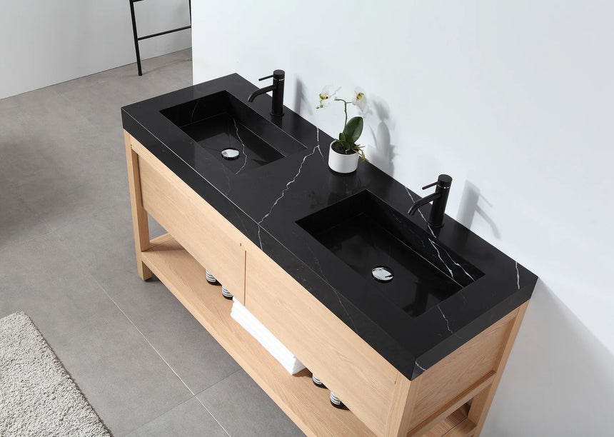 Bathroom vanity with black countertop and wooden cabinet in a bright room.