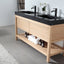 Bathroom vanity with black countertop and wooden cabinet, featuring toiletries.