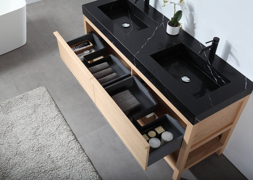 Bathroom vanity with black countertop and wooden cabinet in a bright room.