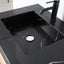 Black marble sink with a black faucet on a countertop.