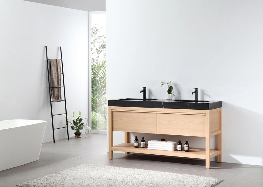 Bathroom vanity with black countertop and wooden cabinet in a bright room.