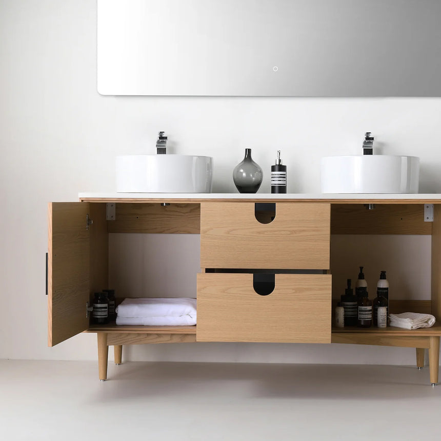Bathroom vanity with two sinks, mirrors, and decorative elements.