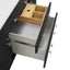 Open drawer with wooden interior and black frame on a white background