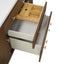 Open wooden cabinet with drawers and a bamboo interior on a white background