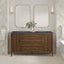 Bathroom vanity with double mirrors, lights, and a vase of flowers.
