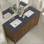 Bathroom vanity with double sink, dark marble countertop, and wooden cabinet.