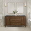 Bathroom vanity with double mirrors, candles, and a flower arrangement.