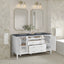 Bathroom vanity with two mirrors, lights, and decorative elements against a tiled wall.