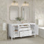 Bathroom vanity with two mirrors, lights, and decorative elements against a tiled wall.