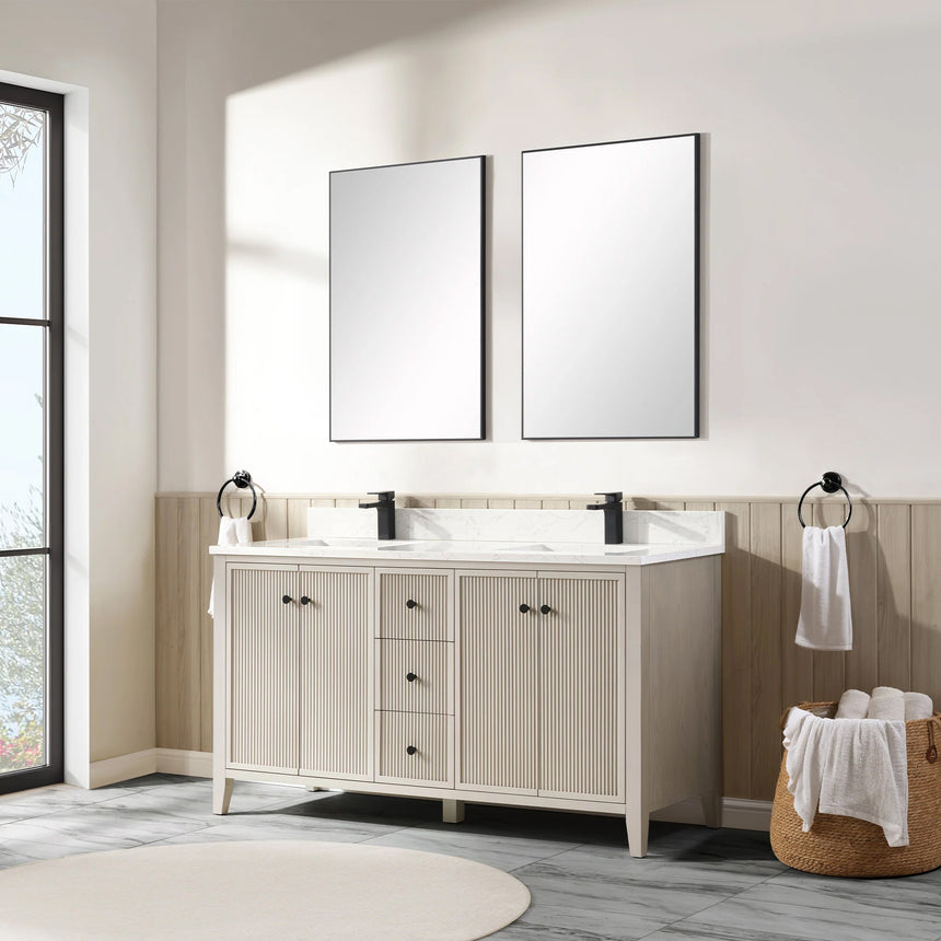 Bathroom vanity with double sink, mirrors, and towels in a well-lit room.