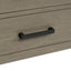 Close-up of a wooden drawer with a black handle on a white background