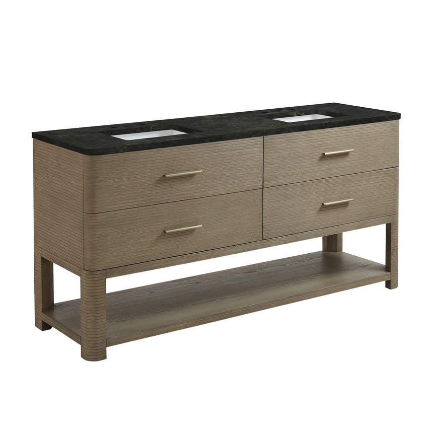 A modern bathroom vanity with a light oak wood frame, six drawers, an open lower shelf, and a white marble top with an integrated sink. The vanity is styled in a bright bathroom with a white freestanding tub, a gold faucet, and a glass shower stall in the background.