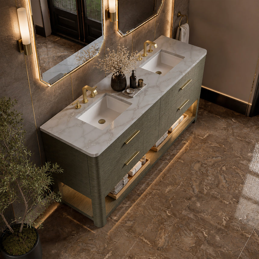 A modern bathroom vanity with a light oak wood frame, six drawers, an open lower shelf, and a white marble top with an integrated sink. The vanity is styled in a bright bathroom with a white freestanding tub, a gold faucet, and a glass shower stall in the background.