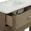 Close-up of a modern vanity or cabinet with a fluted wood front, one drawer pulled open to reveal a light beige interior, and a white marble-look countertop with an undermount sink.