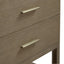 Close-up of a wooden drawer with gold handles on a white background