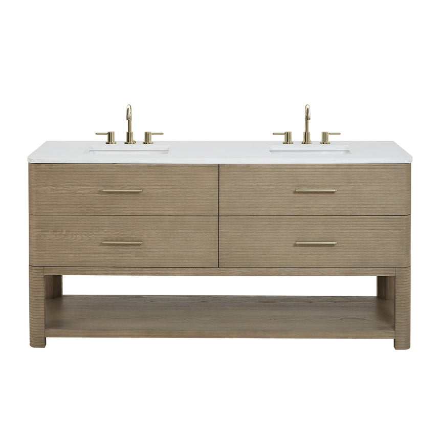 A modern bathroom vanity with a light oak wood frame, six drawers, an open lower shelf, and a white marble top with an integrated sink. The vanity is styled in a bright bathroom with a white freestanding tub, a gold faucet, and a glass shower stall in the background.