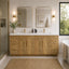 Bathroom with wooden vanity, mirrors, and a bathtub.