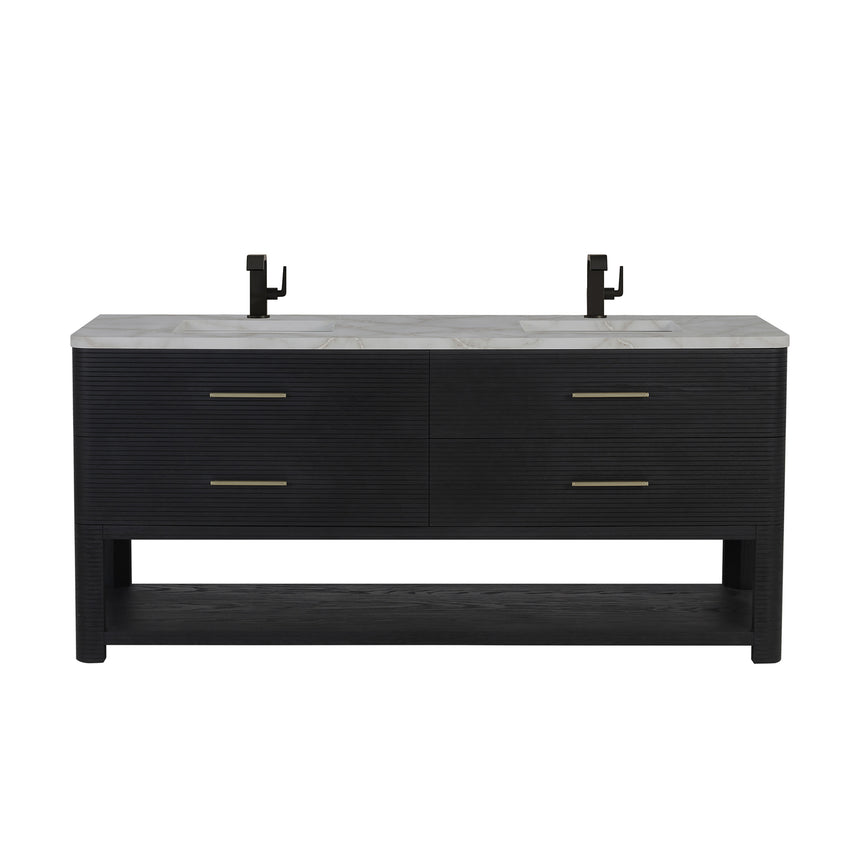 A modern bathroom vanity with a light oak wood frame, six drawers, an open lower shelf, and a white marble top with an integrated sink. The vanity is styled in a bright bathroom with a white freestanding tub, a gold faucet, and a glass shower stall in the background.